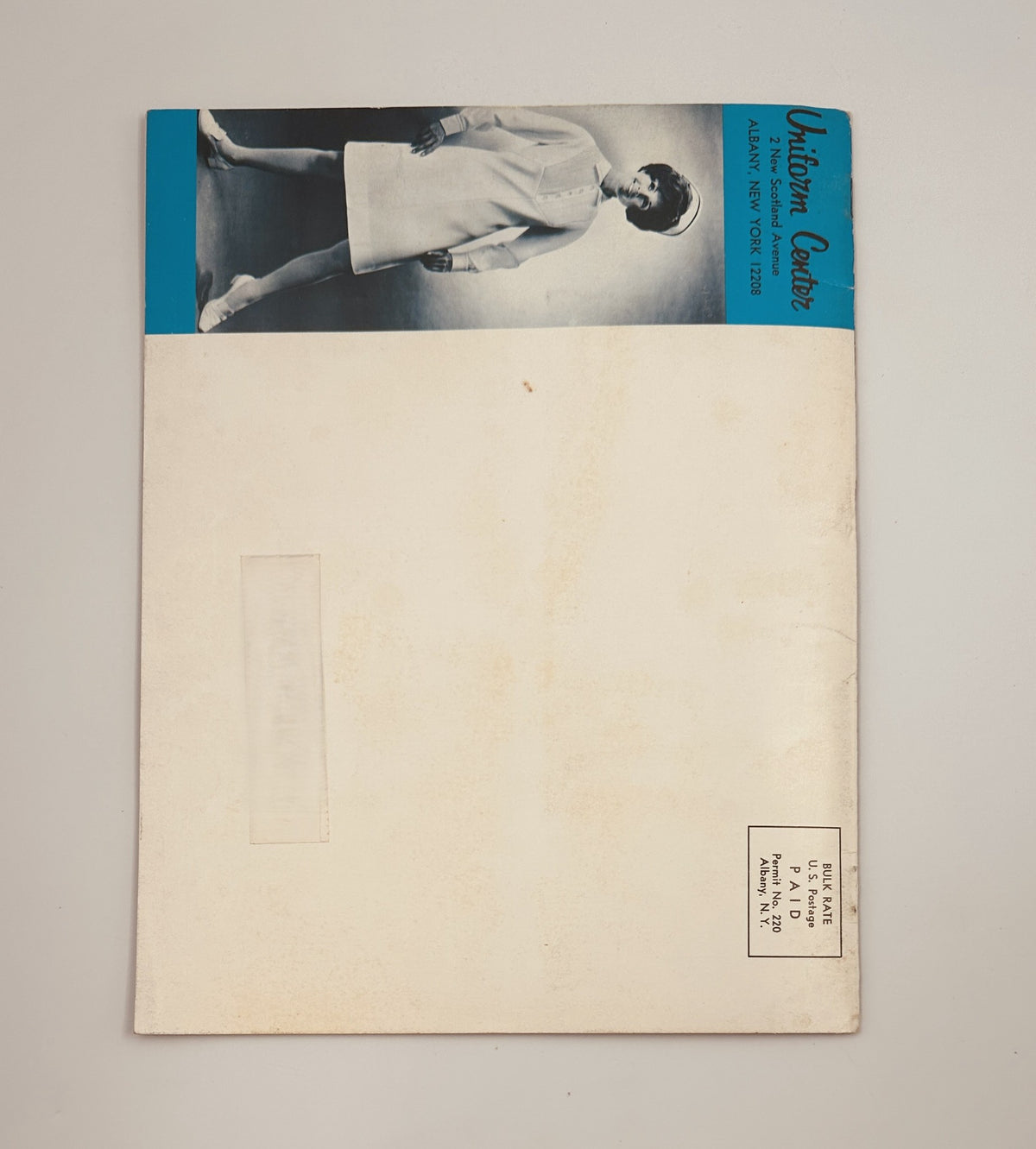 Back cover of the Fall/Winter 1969-1970 Uniform Center Catalog, featuring a model in a nurse uniform, showcasing classic medical fashion with a simple design. Perfect for collectors of vintage fashion and medical history.