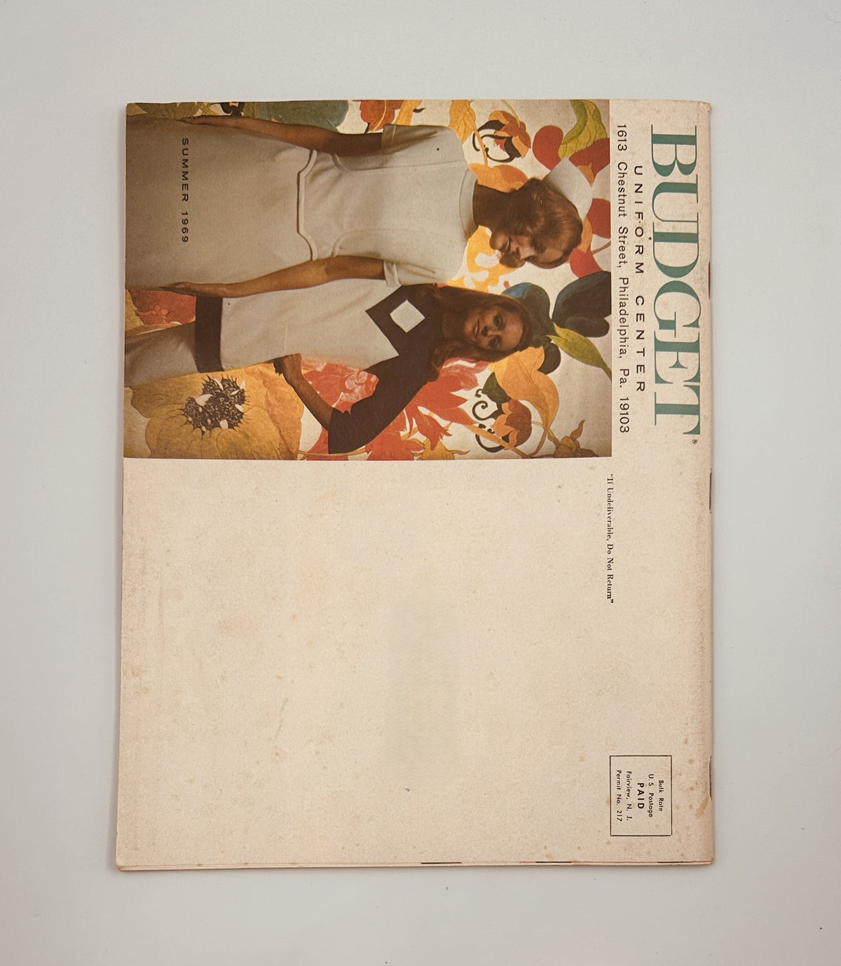 Back cover of the Budget Uniform Center Catalog Summer 1969, showcasing a vintage design with floral elements and model imagery, reflecting the nostalgic fashion of the era.