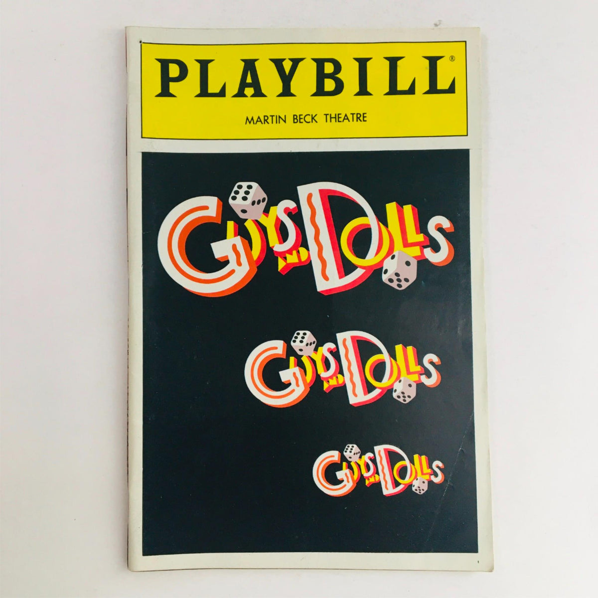 1992 Playbill for Guys and Dolls at Jerry Zaks at Martin Beck Theatre featuring vibrant cover design with dice and iconic logo.