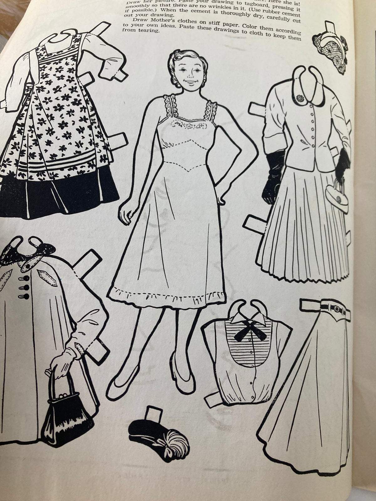 A dress-up paper doll page from the VTG Children's Activities Magazine October 1952 Vol 18 #8, showcasing various paper clothes and accessories for creative play.