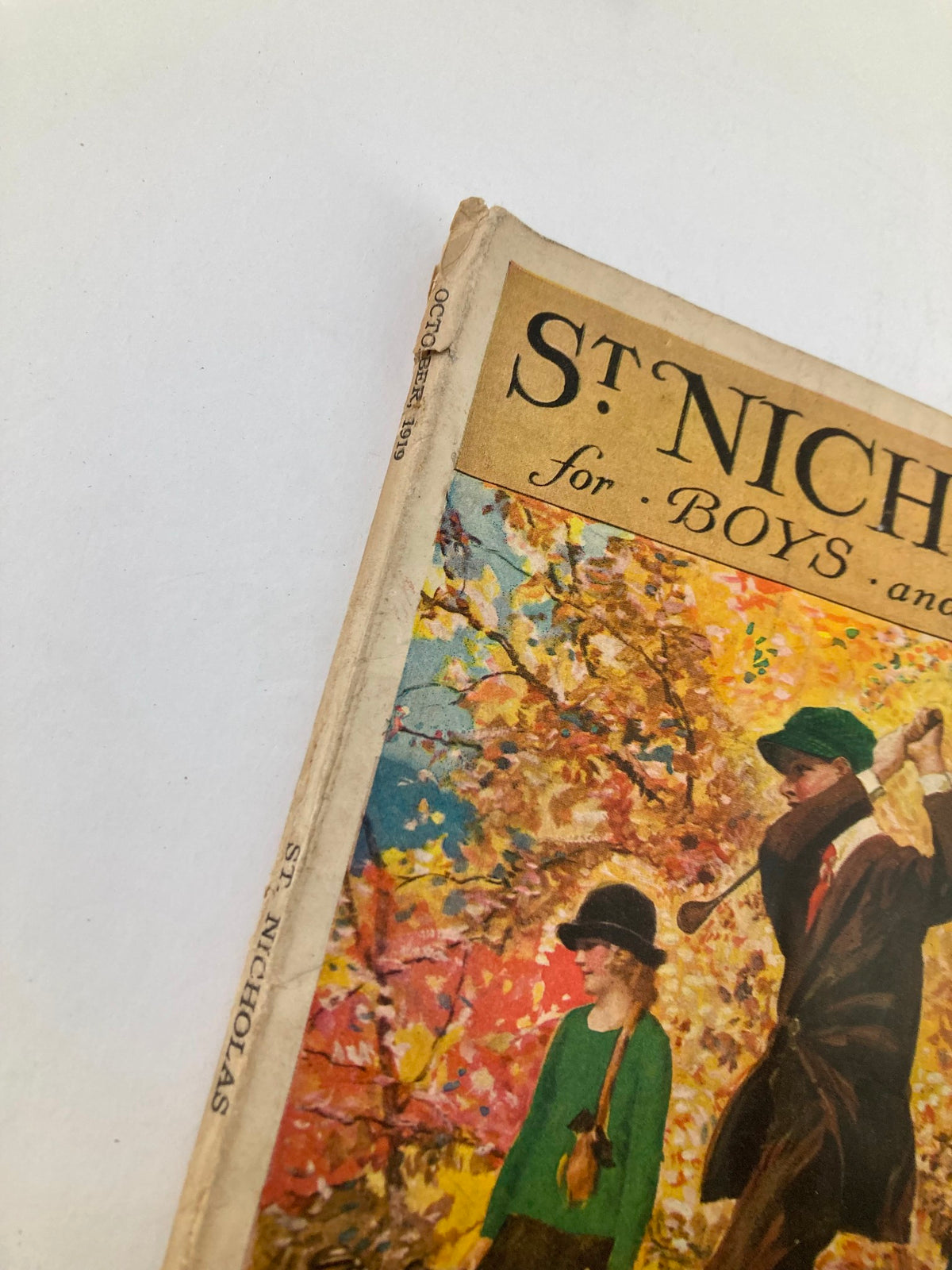 Close-up view of the spine and corner of the St. Nicholas Magazine October 1919, highlighting its vintage condition and artistic cover design.
