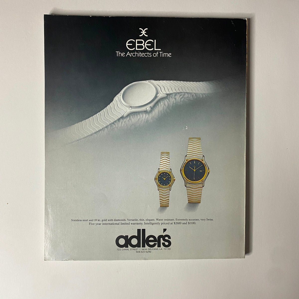 Advertisement for EBEL watches featuring the slogan "The Architects of Time". The image showcases elegant watches with diamond features made of stainless steel and 18K gold, emphasizing their versatility and accuracy. Title: Connoisseur Magazine December 1985 Inside Lagerfeld's Mind No Label.