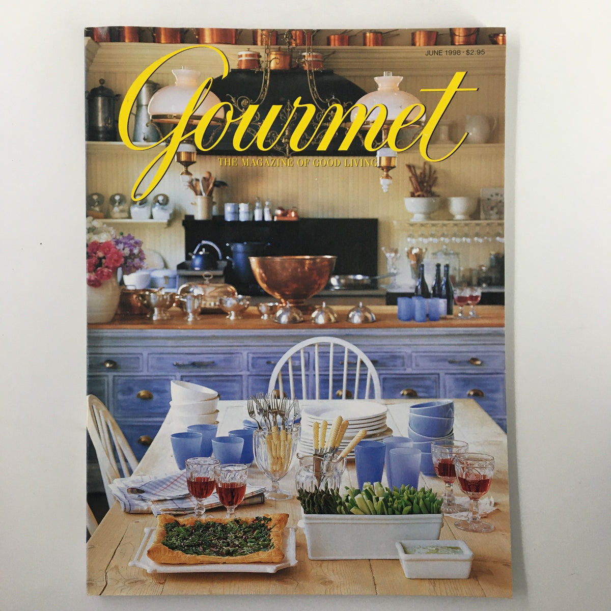 Cover of Gourmet Magazine June 1998 featuring a well-set dining table with a rustic kitchen background. This issue includes the Little Black Book on Seville's sherry marvels.
