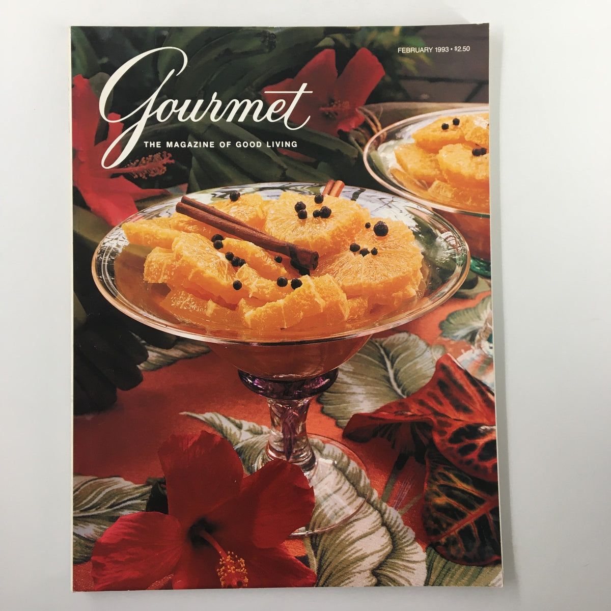 Gourmet Magazine February 1993 featuring a vibrant cover with a bowl of orange slices decorated with spices, surrounded by tropical foliage and floral accents, showcasing a Festive Caribbean Dinner.