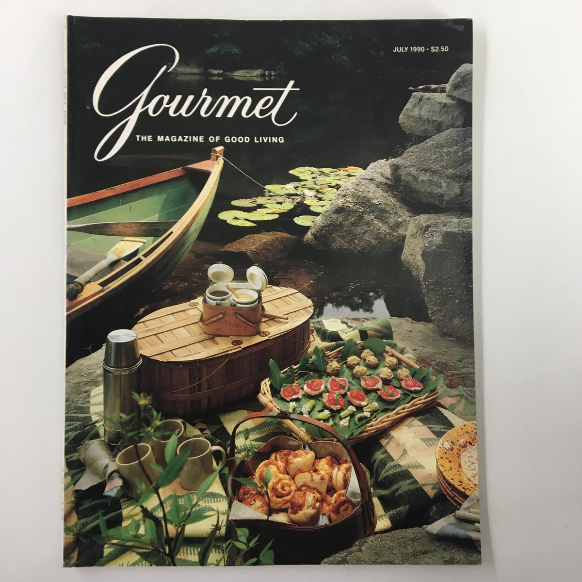 Cover of Gourmet Magazine July 1990, titled 'Smack in Summer Center Gourmet Menus'. The cover features a picturesque summer picnic scene by a lake, showcasing gourmet food and a boat.