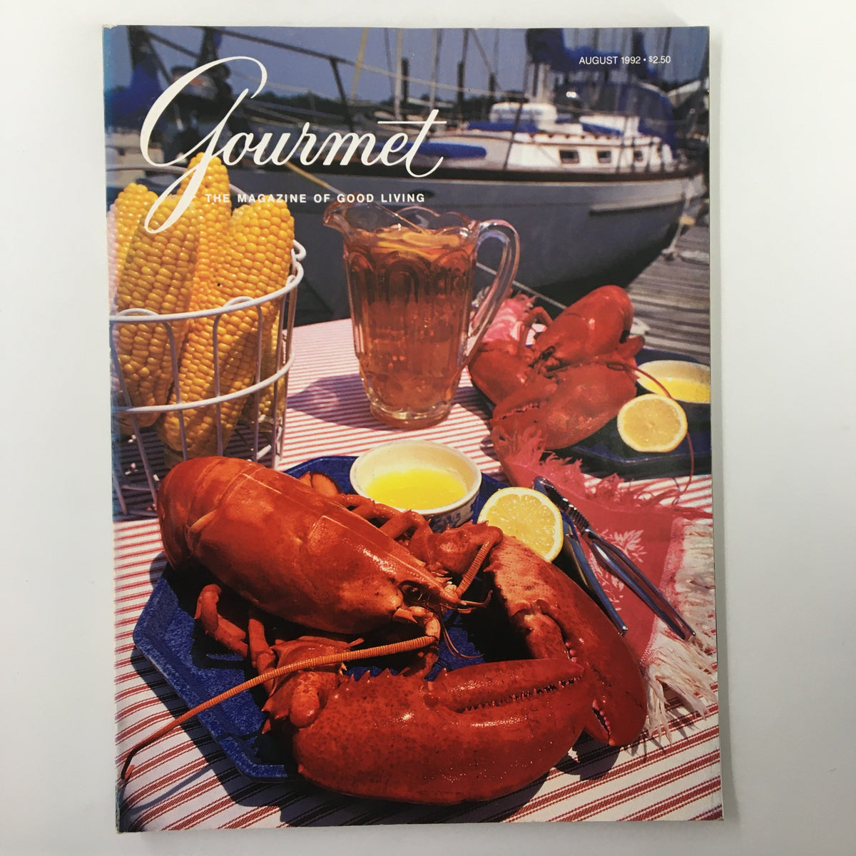 Cover of Gourmet Magazine August 1992 featuring lobsters, corn, and a pitcher on a table by the waterfront. Title: King of Crustaceans Comes to the Table.