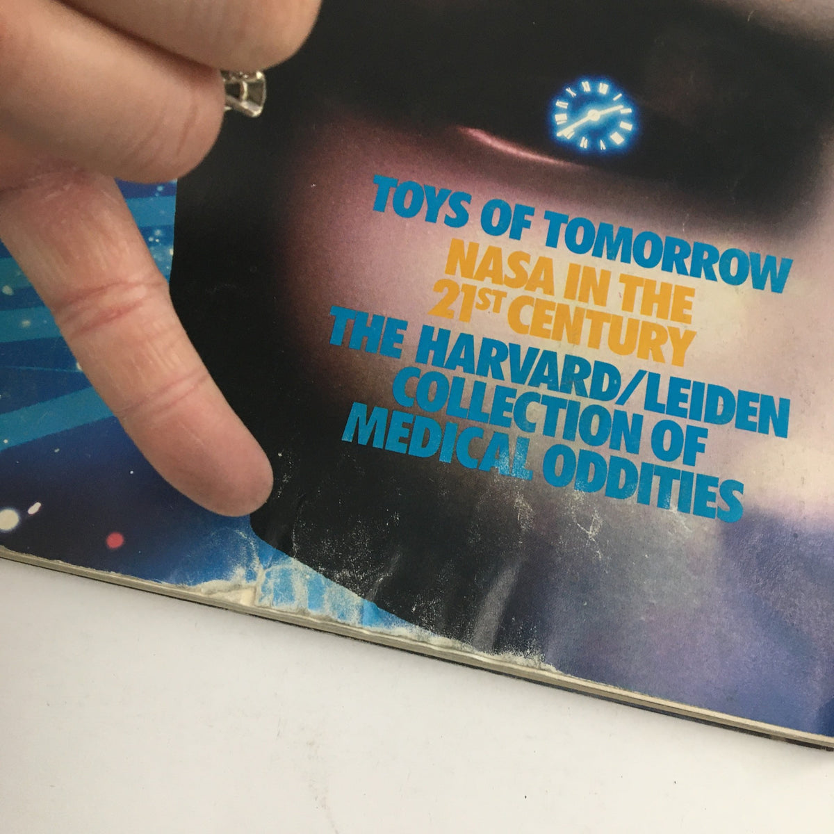 Close-up of the cover of Omni Magazine December 1987 highlighting the text 'Toys of Tomorrow', 'NASA in the 21st Century', and 'The Harvard/Leiden Collection of Medical Oddities'.