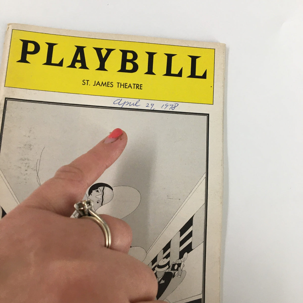 Close-up view of the 1978 Playbill for 'On The Twentieth Century,' highlighting the date written 'April 29, 1978' and playful finger pointing gesture.