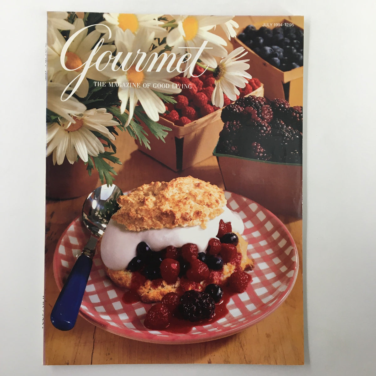 Cover of Gourmet Magazine July 1994 featuring a delicious Sour Cream Shortcake topped with summer berries, surrounded by fresh flowers and baskets of berries.