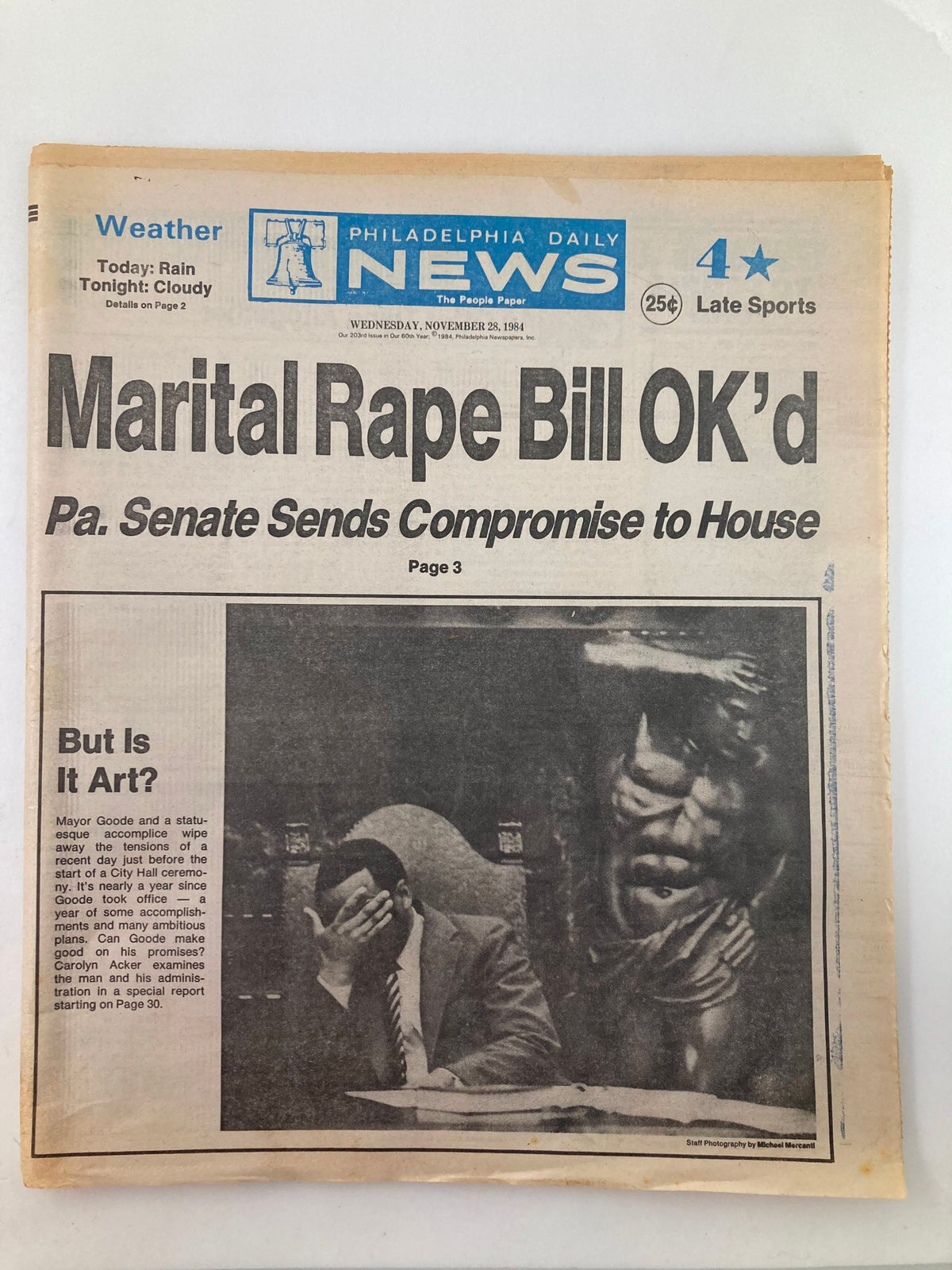 Philadelphia Daily News tabloid from November 28, 1984, featuring a headline on marital rape bill approval, and an article about Mayor Goode, alongside artistic commentary. The newspaper includes weather information and sports news.