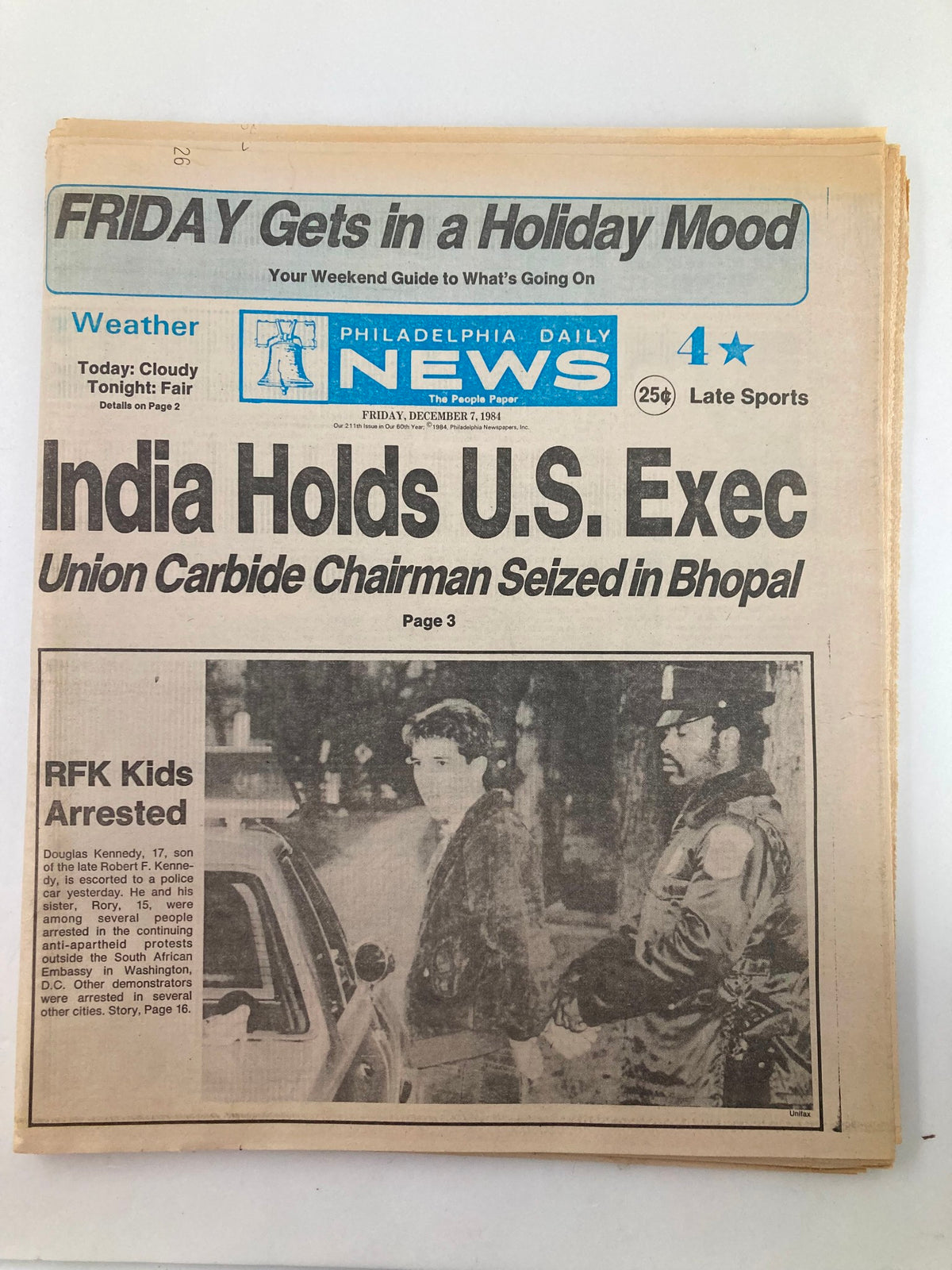 Philadelphia Daily News Tabloid December 7 1984 featuring headline 'India Holds U.S. Exec' and photograph of Douglas Kennedy handcuffed by police at a protest, good condition with minor wear.