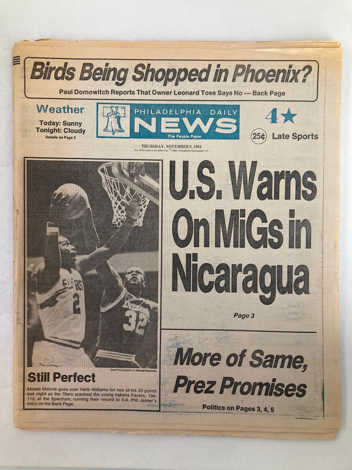 Philadelphia Daily News Tabloid from November 8, 1984, featuring a headline about U.S. warnings in Nicaragua and highlighting sports events, including a feature on Moses Malone of the Philadelphia 76ers. The tabloid captures significant moments in sports and journalism from the 1980s.