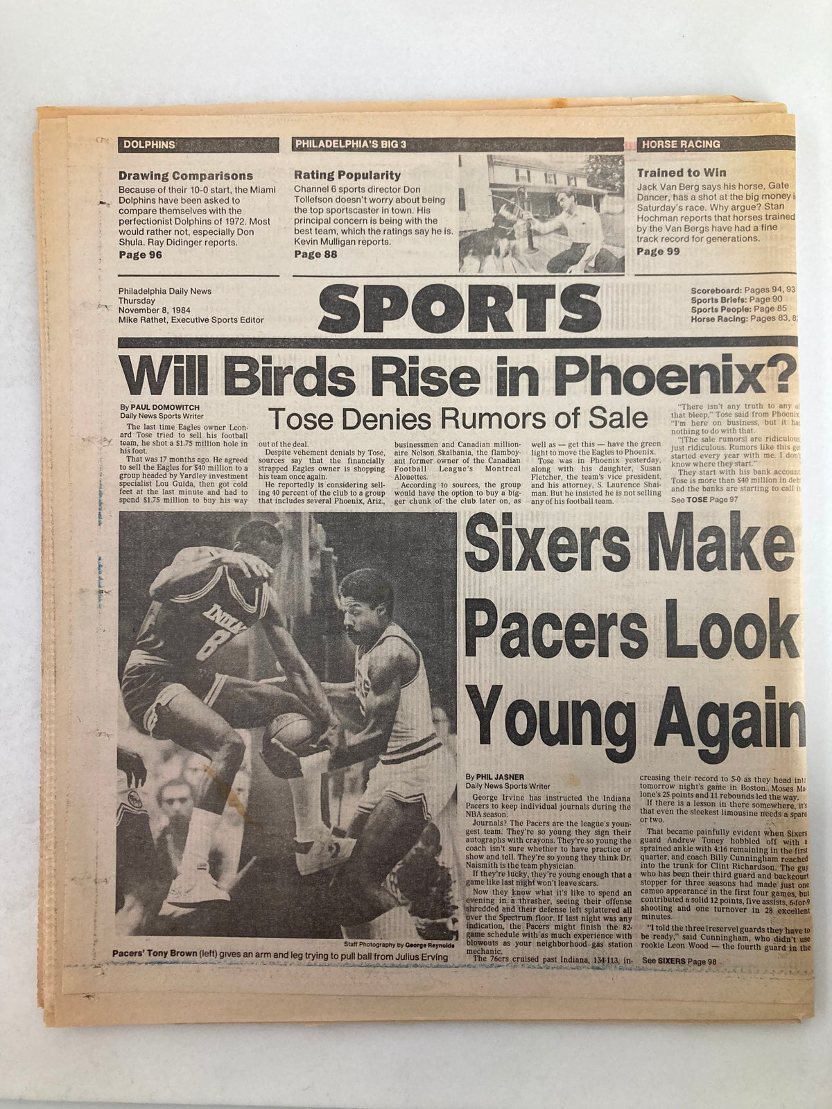 Philadelphia Daily News Tabloid from November 8, 1984, featuring sports headlines including 'Will Birds Rise in Phoenix?' and 'Sixers Make Pacers Look Young Again'. The image highlights a basketball action shot involving players from the Indiana Pacers and the Philadelphia 76ers, capturing the excitement of 1980s basketball.