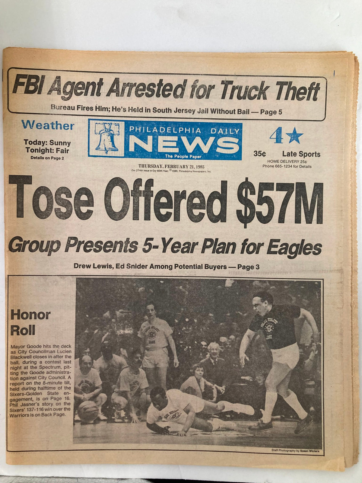Philadelphia Daily News tabloid from February 21, 1985, featuring headlines about an FBI agent arrested for truck theft and sports news, including a $57M offer for the Eagles. Contains photos and text related to local events and the Honor Roll.