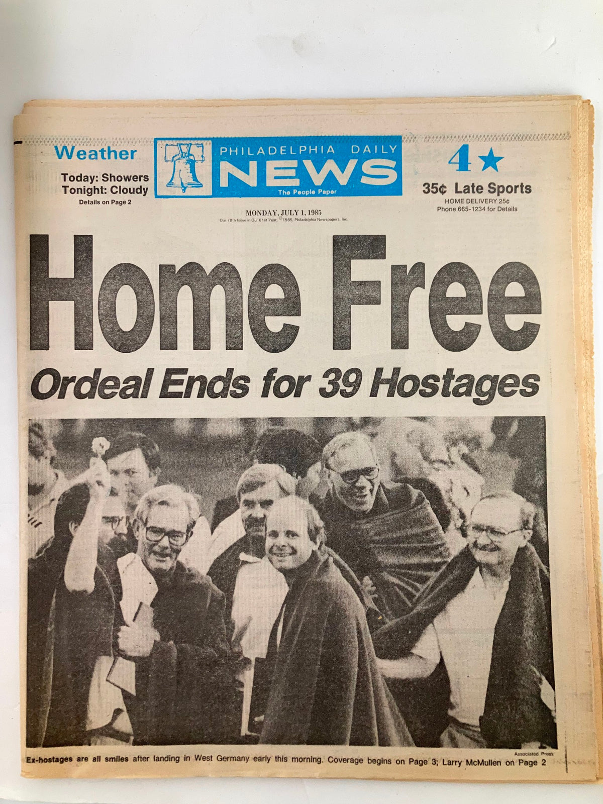 Philadelphia Daily News tabloid from July 1, 1985 titled 'Home Free: Ordeal Ends for 39 Hostages', featuring images of ex-hostages smiling after returning to West Germany.