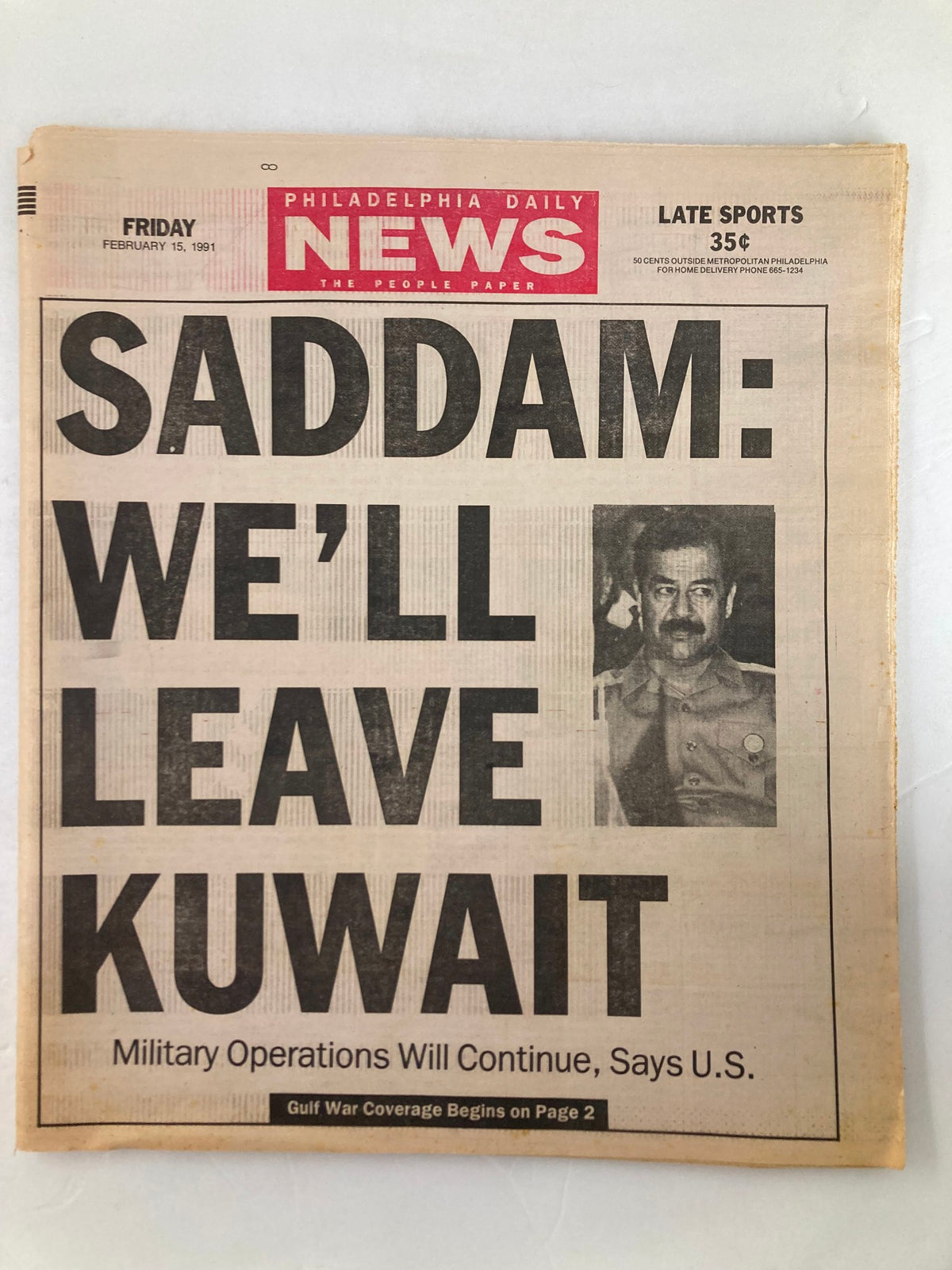 Philadelphia Daily News Tabloid from February 15, 1991, featuring the headline 'SADDAM: WE'LL LEAVE KUWAIT' with a photo of Saddam Hussein. This historic newspaper covers the Gulf War and military operations.