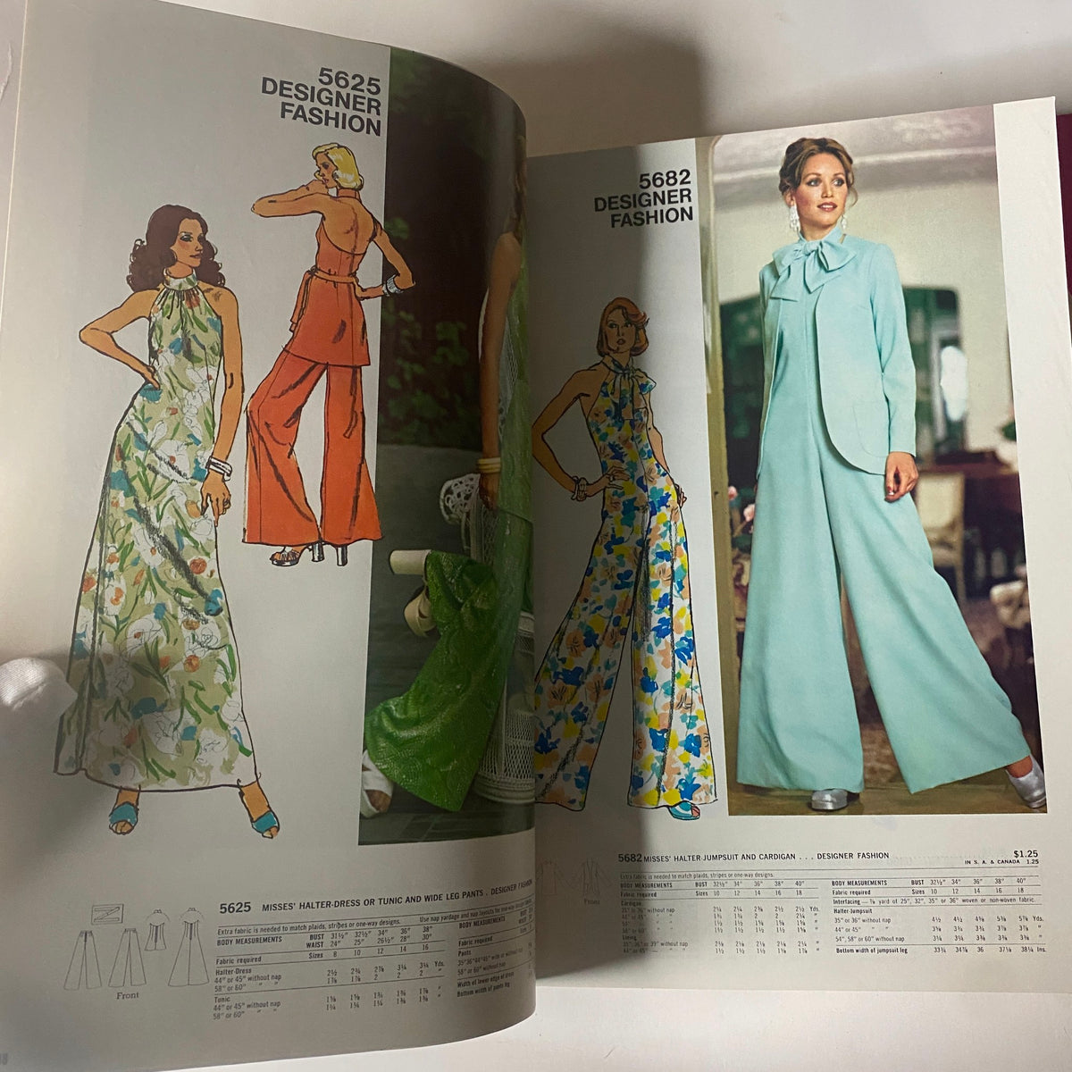 1973 July Simplicity Catalog showcasing designer fashion sewing patterns including a floral halter dress and a stylish jumpsuit, reflecting 1970s summer fashion.