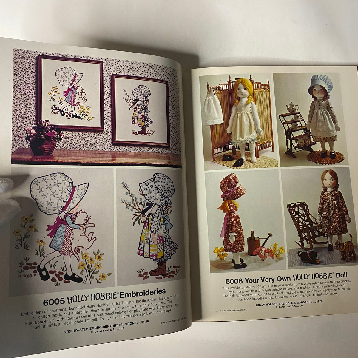 Illustrations from the 1973 Simplicity Holiday Gift Catalog highlighting Holly Hobbie embroidery patterns and doll designs, celebrating vintage holiday crafting.