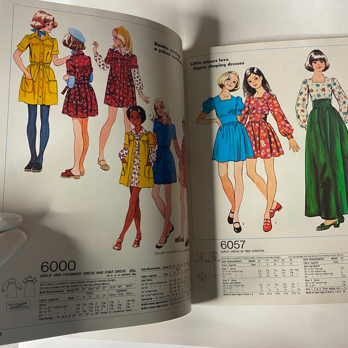 1973 Simplicity Holiday Gift Catalog page displaying vibrant girl’s dresses, highlighting sewing patterns for casual and playful styles, perfect for young fashion.