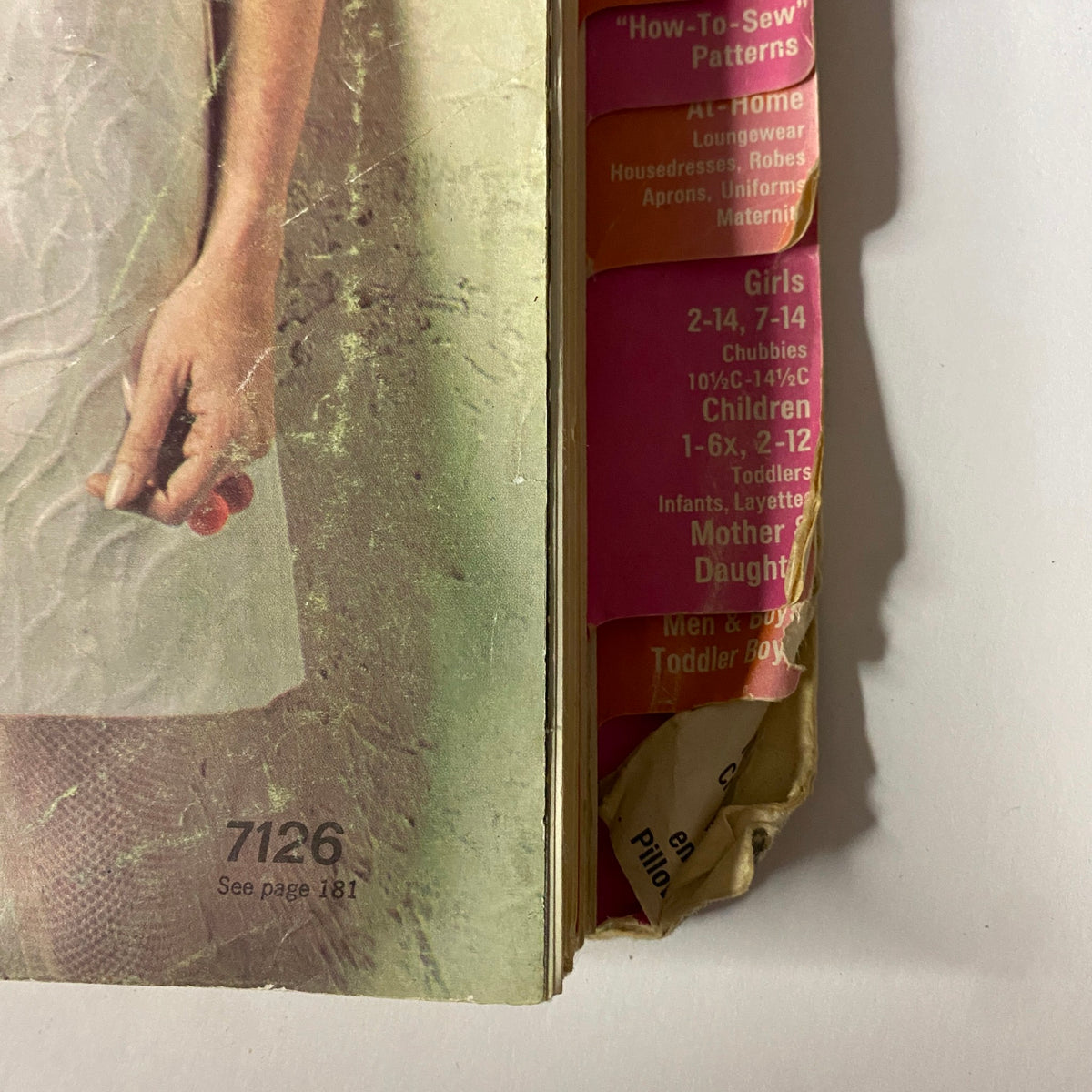 Close-up of the side of the 1967 June Simplicity Sewing Pattern Catalog displaying categorized patterns for girls and mothers, highlighting the diverse offerings of 1960s fashion.
