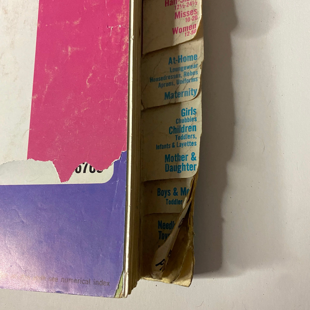 Reverse side view of the 1967 January Simplicity Catalog, featuring tabs for different sewing categories including Maternity and Girls' Fashions, showcasing the extensive range of sewing patterns available.