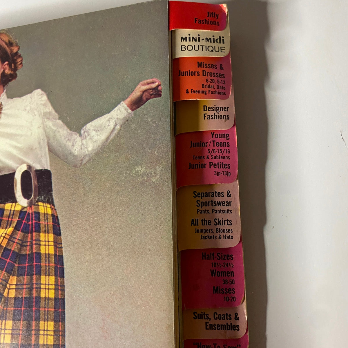 Detailed view of the 1968 September Simplicity Catalog spine, emphasizing sections such as Jiffy Fashions and mini-midi boutique styles. A great resource for vintage fashion sewing patterns.