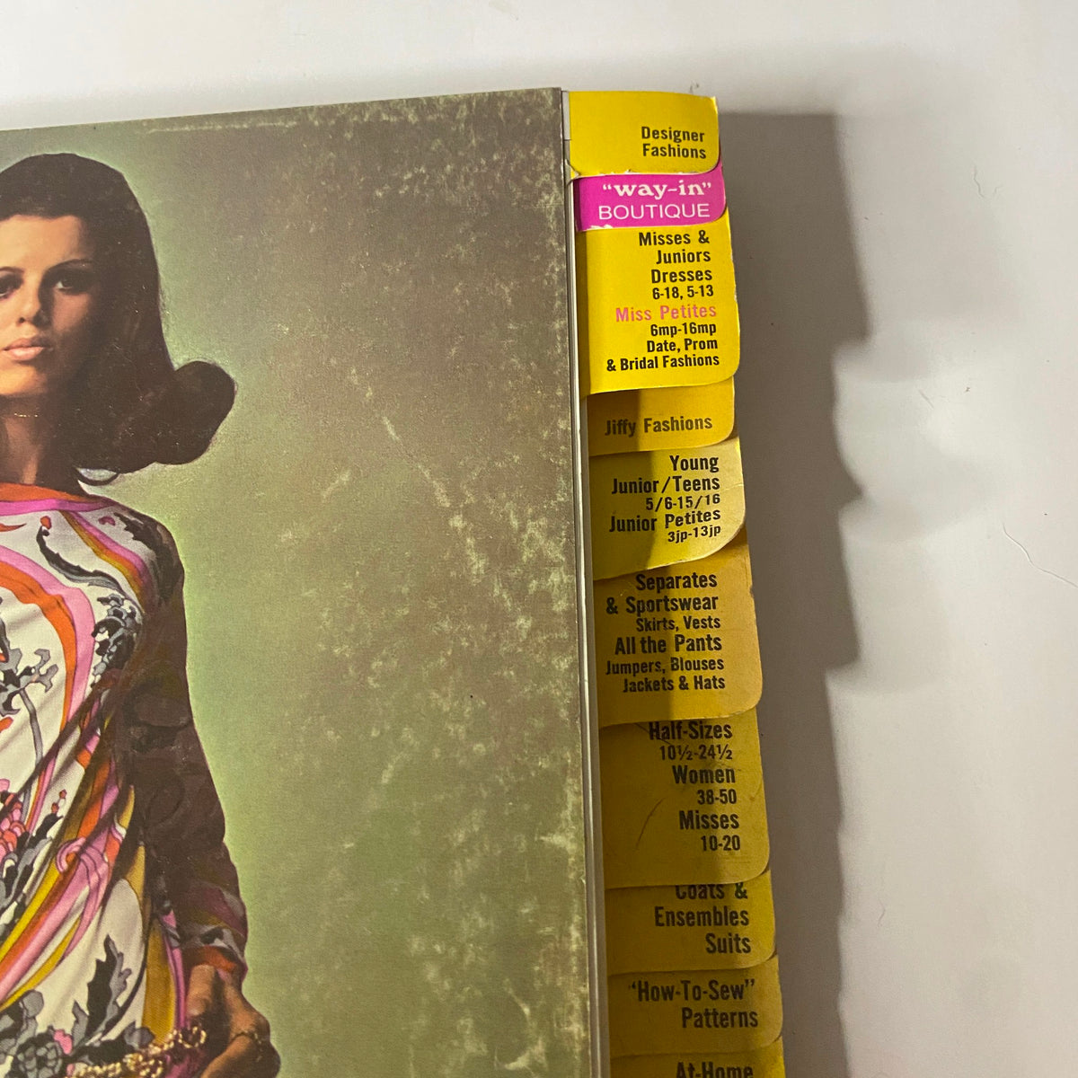 Close-up of the side of the 1969 May Simplicity Catalog, showing categorized sections for various fashion styles including Designer Fashions and Jiffy Fashions.