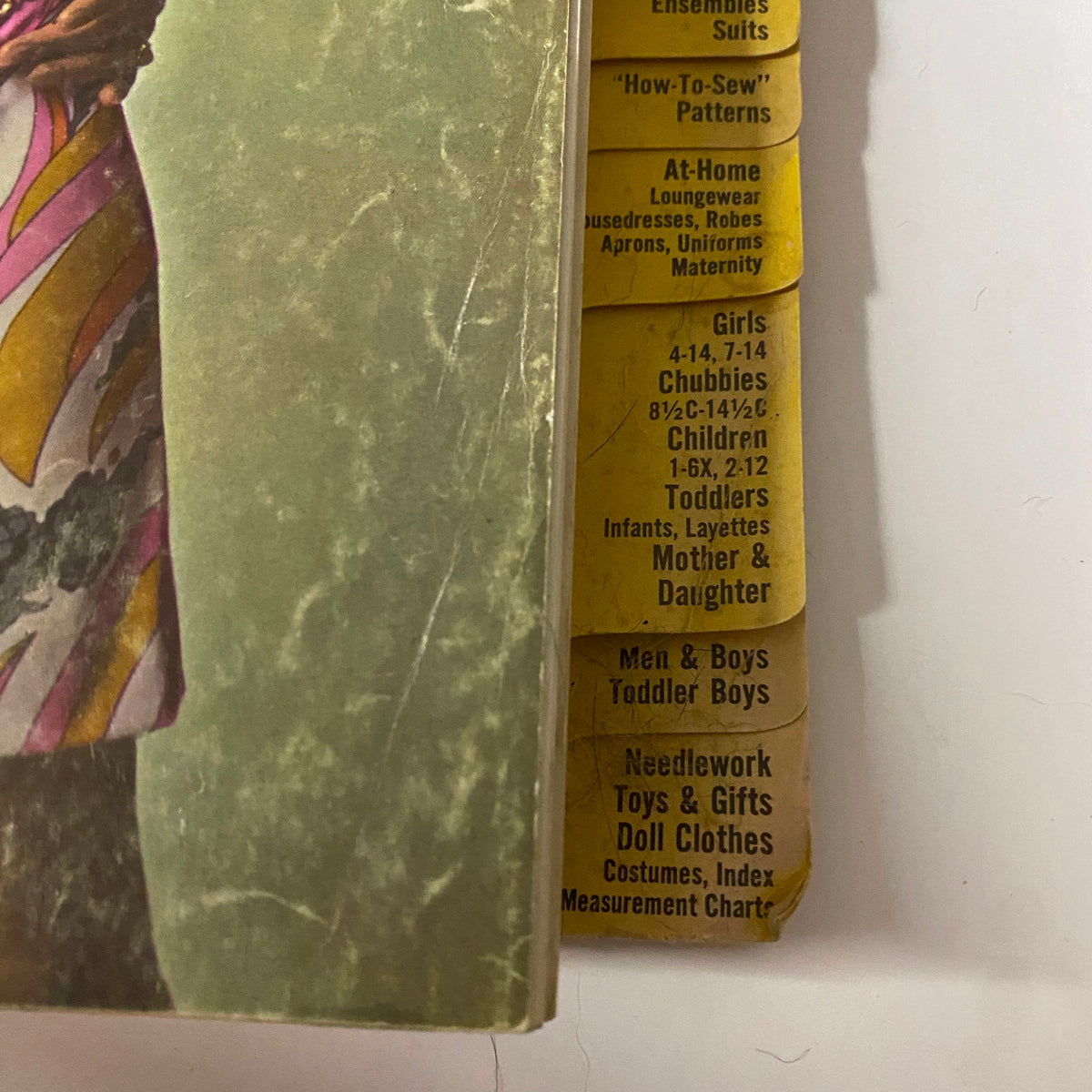 Cover of the 1969 May Simplicity Catalog Sewing Pattern Store featuring a model in a colorful dress and categories for different sewing pattern styles such as How-To-Sew Patterns, Girls, and Toddlers. Part of the original May Simplicity catalog collection.