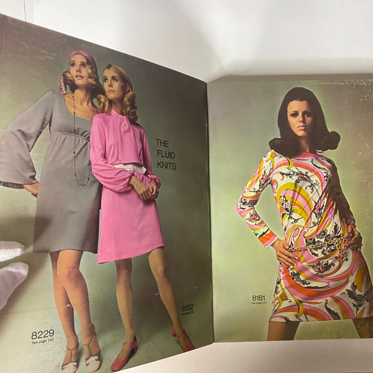 Inside spread of the 1969 May Simplicity Catalog showcasing stylish models wearing 'Fluid Knits' dresses along with pattern numbers 8229 and 8181, highlighting designs from the late 1960s.
