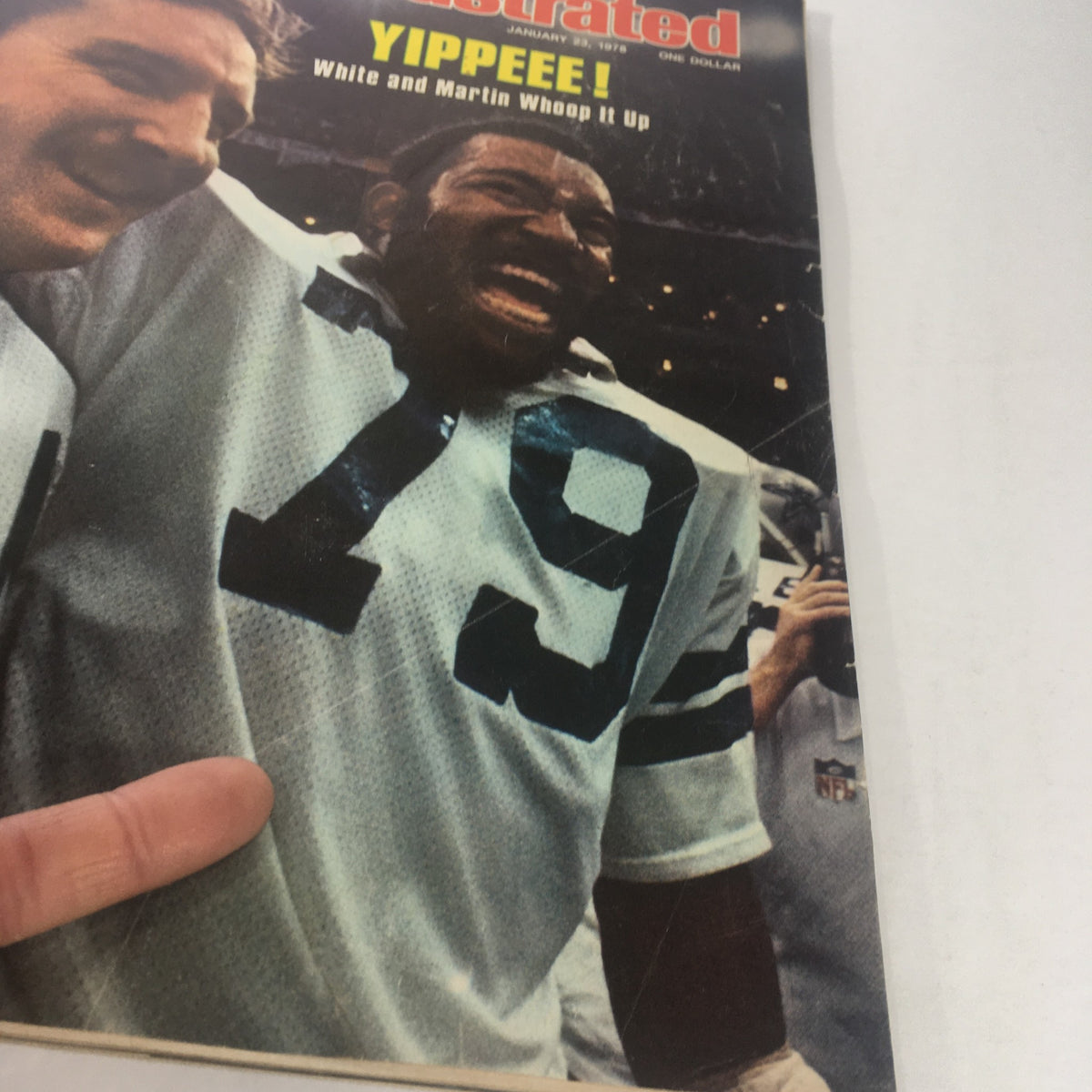 Close-up of the cover of Sports Illustrated Magazine from January 23, 1978, featuring athletes Danny White and Harvey Martin in celebration.