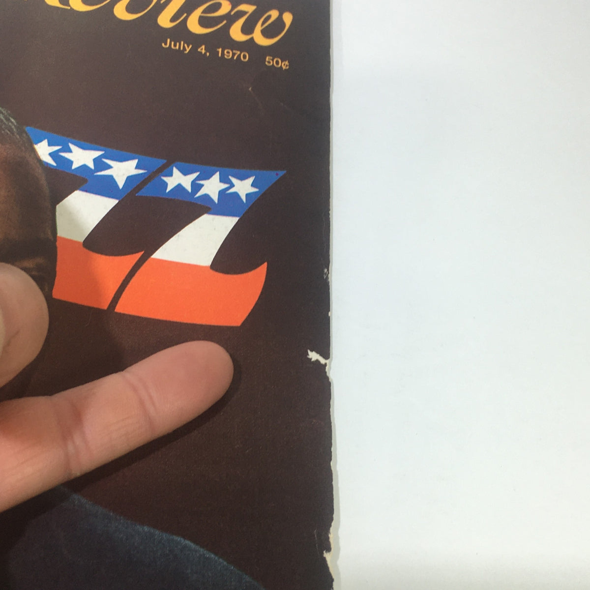 Detail of the edge of the cover of VTG Saturday Review: July 4 1970 - A Symposium On Louis Armstrong, highlighting wear and the magazine title.