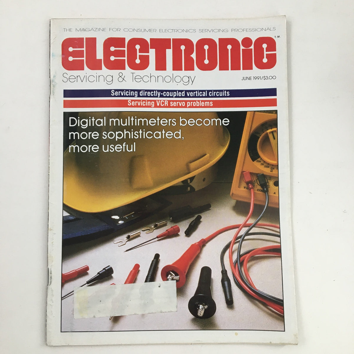 Cover of Electronic Servicing & Technology Magazine June 1991, featuring a focus on servicing VCR servo problems and digital multimeters, alongside various electronic tools.