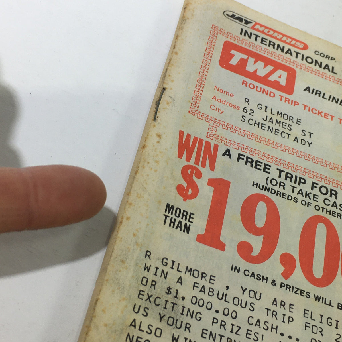 Close-up of the VTG 1977 Jay Norris Corporation Travel Division Price Guide Calendar Catalog cover promoting a chance to win a free trip to Paris, highlighting more than $19,000 in cash and prizes, with an emphasis on the bold red text.