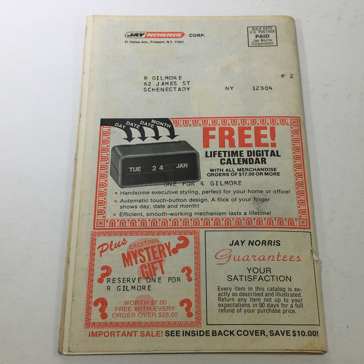 Back cover of the VTG 1977 Jay Norris Corporation Travel Division Price Guide Calendar Catalog featuring a mailing address, promotional offers for a free lifetime digital calendar, and a mystery gift.
