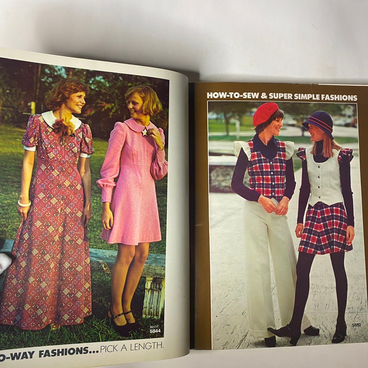 Fashion illustrations from the 1973 Simplicity Fall and Winter School Catalog displaying a variety of dresses and simple sewing patterns.