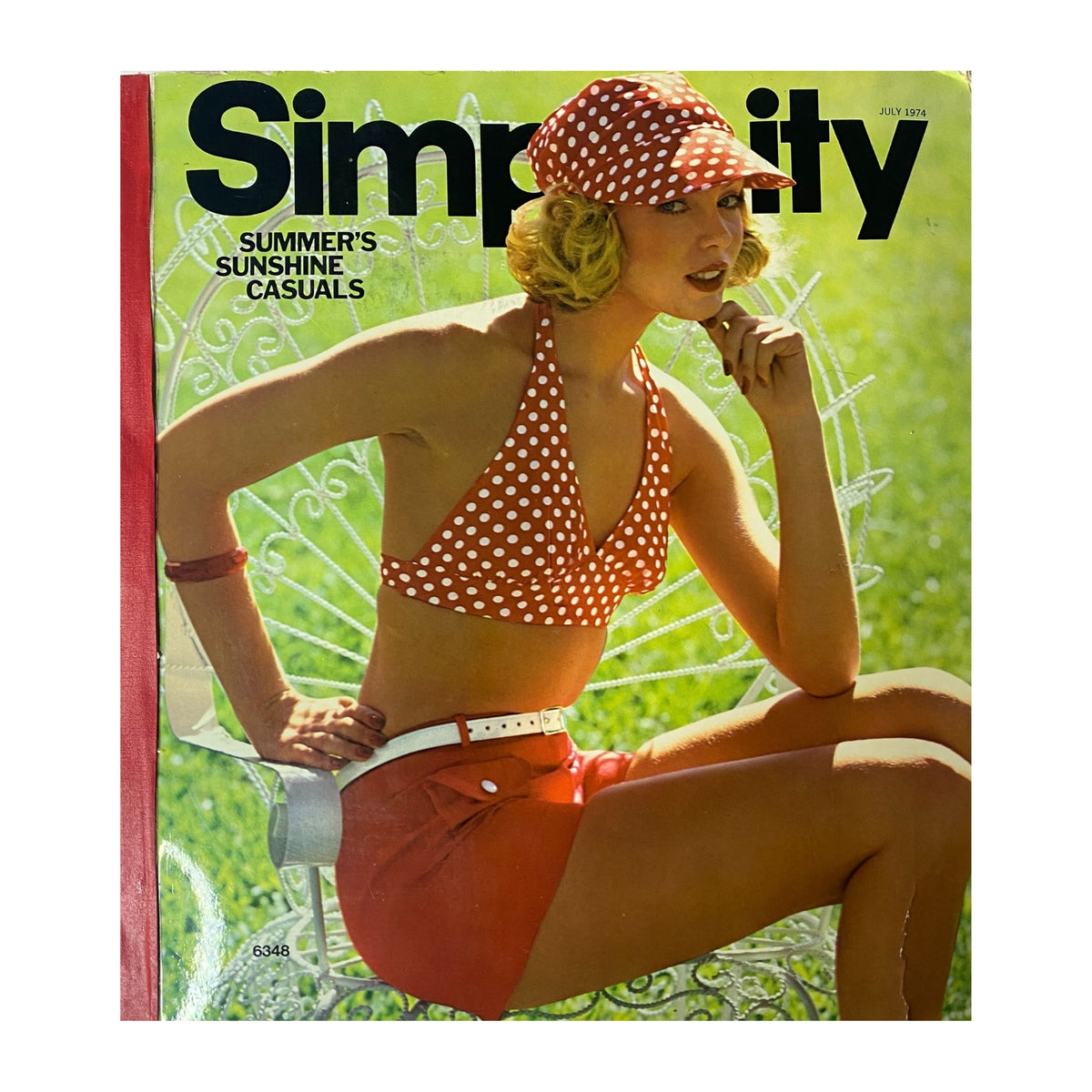 1974 July Simplicity Summer Catalog showcasing a model wearing a polka dot bikini and shorts, embodying 1970s summer fashion. The catalog is titled 'Summer's Sunshine Casuals' and illustrates vibrant, carefree styles from the era.