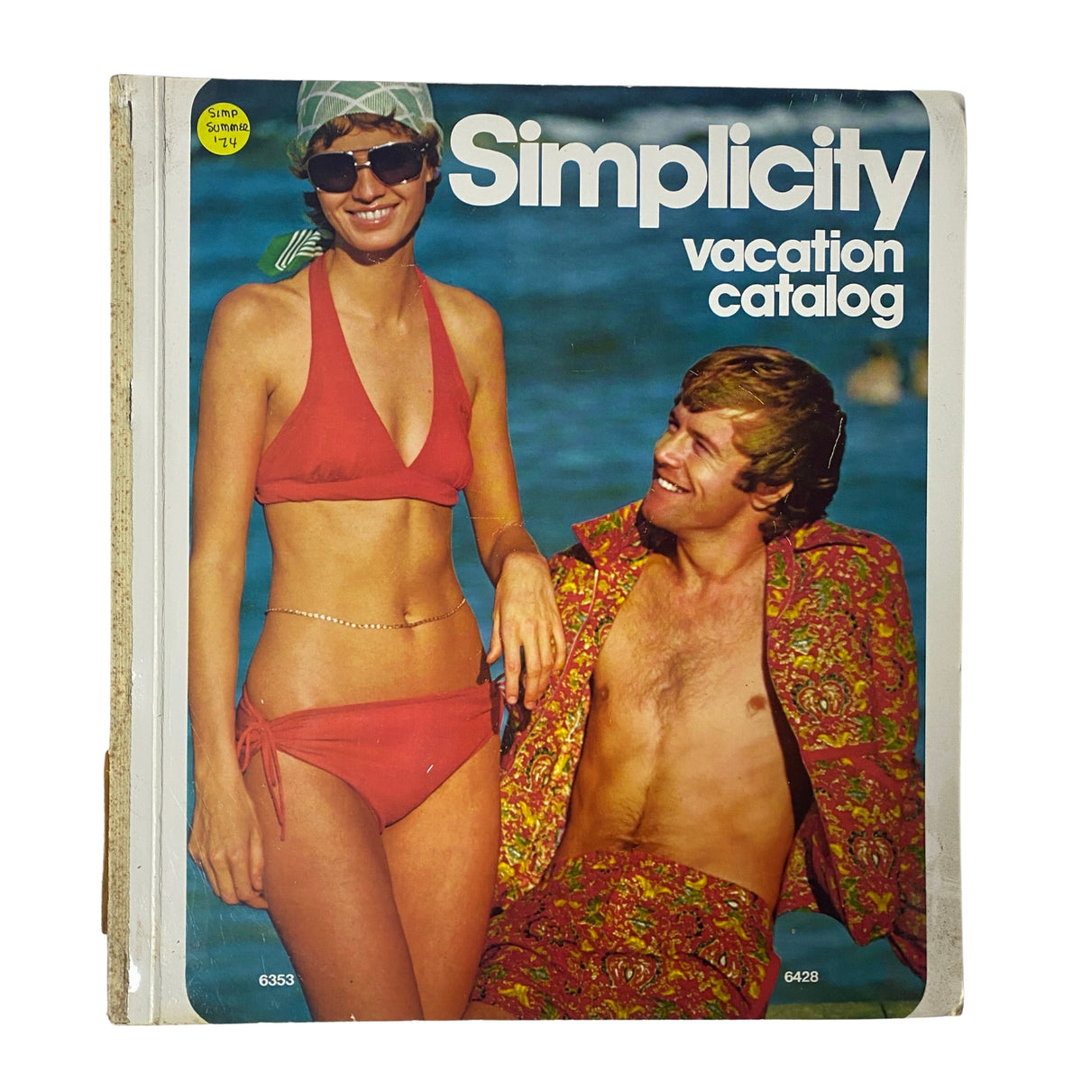 1974 Simplicity Summer Catalog showcasing a vacation theme with a couple on the cover, the woman in a red bikini and sunglasses, and the man in a colorful patterned shirt.