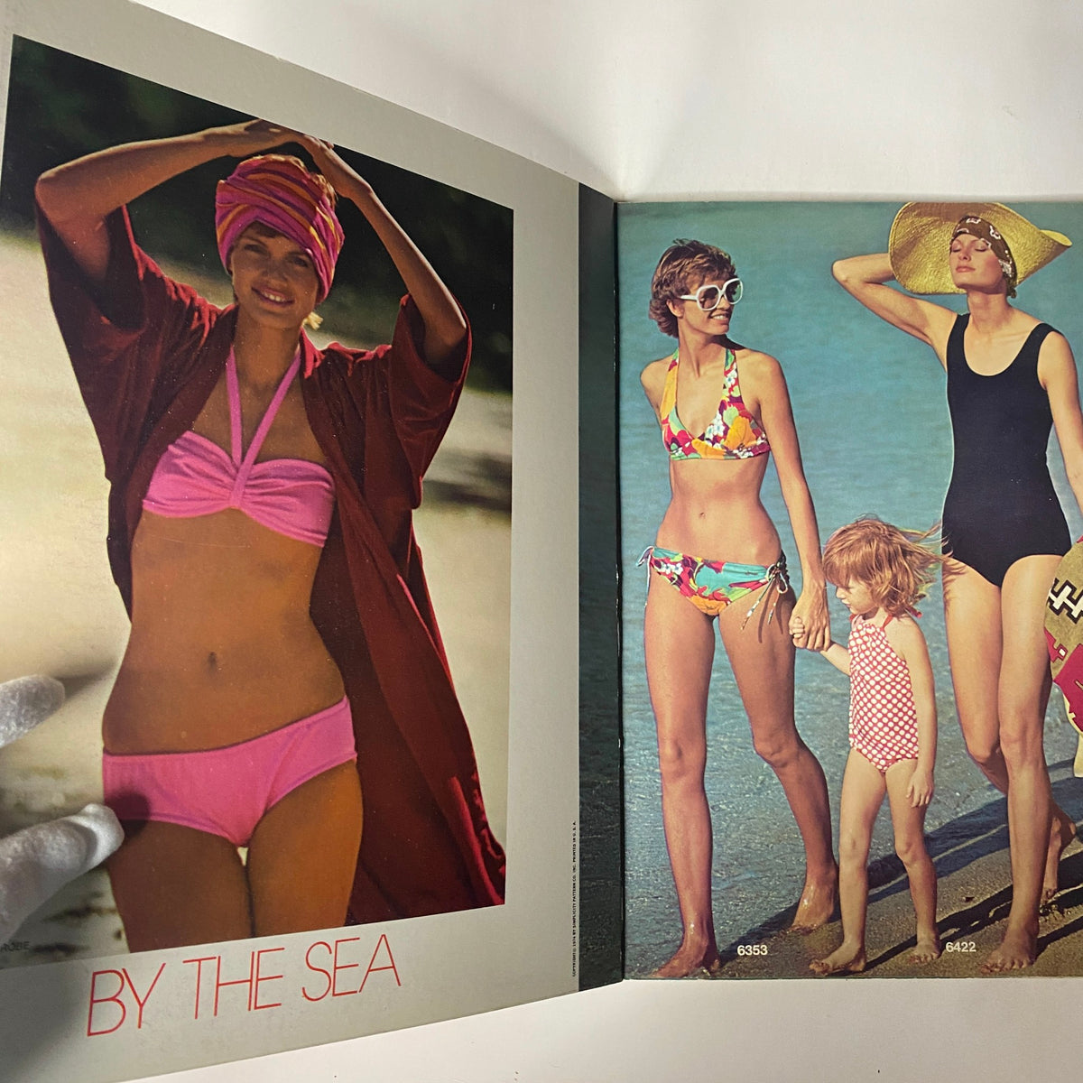 1974 Simplicity Summer Catalog featuring vintage swimwear styles 'By The Sea', showcasing women in colorful bikinis and a girl in a playful swimsuit.