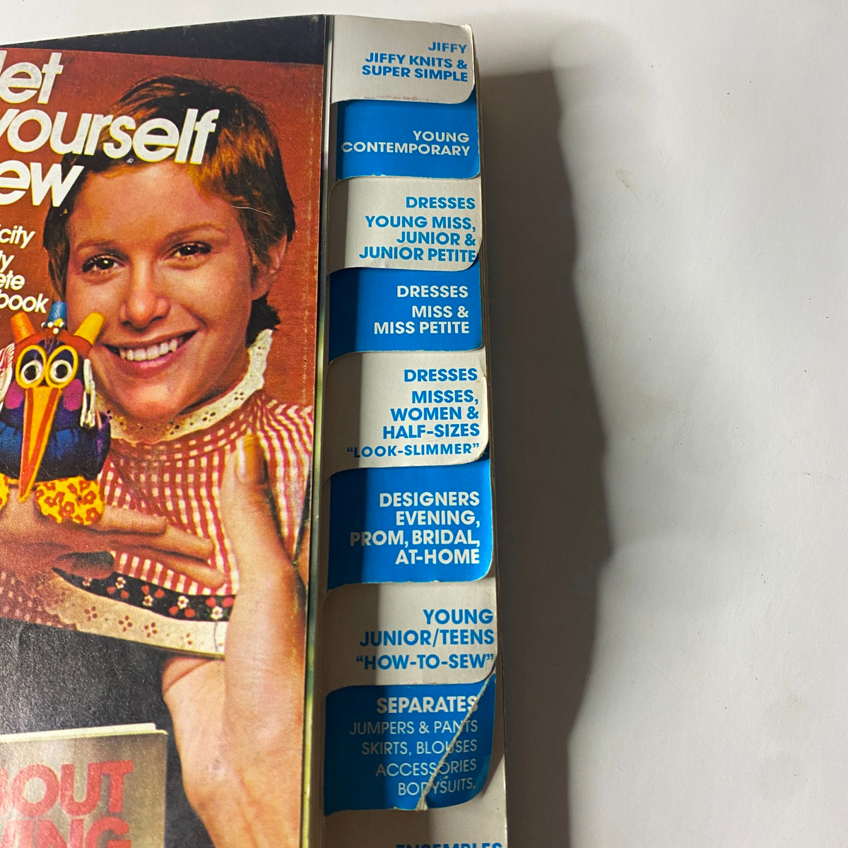 Spine view of the 1974 June Simplicity Catalog, detailing various fashion categories including Jiffy and Young Contemporary styles, ideal for collectors and DIY fashion designers.