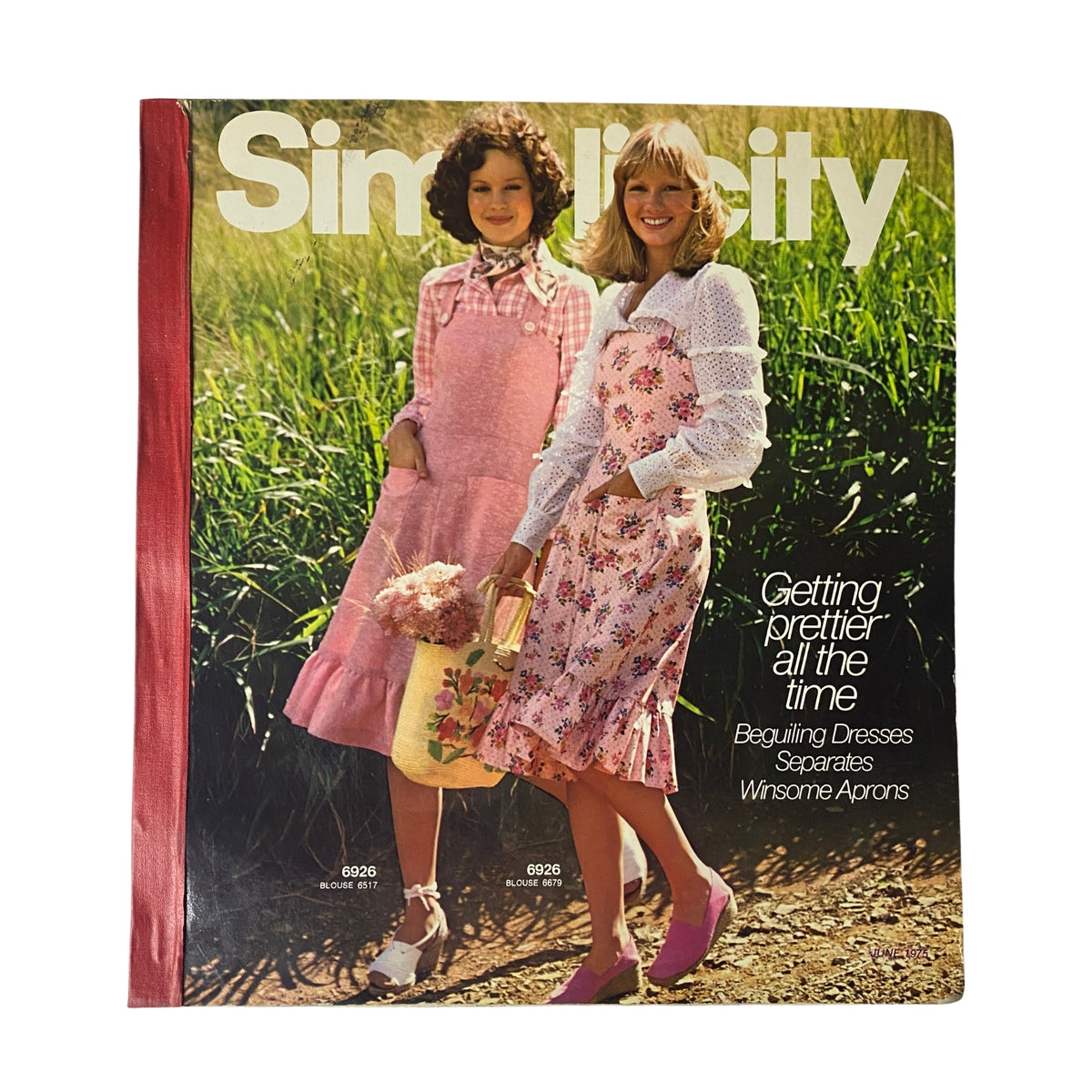 Cover of the 1975 June Simplicity Catalog featuring models in fashionable summer dresses, showcasing sewing patterns for getting 'Prettier All the Time,' including beguiling dresses and separates.
