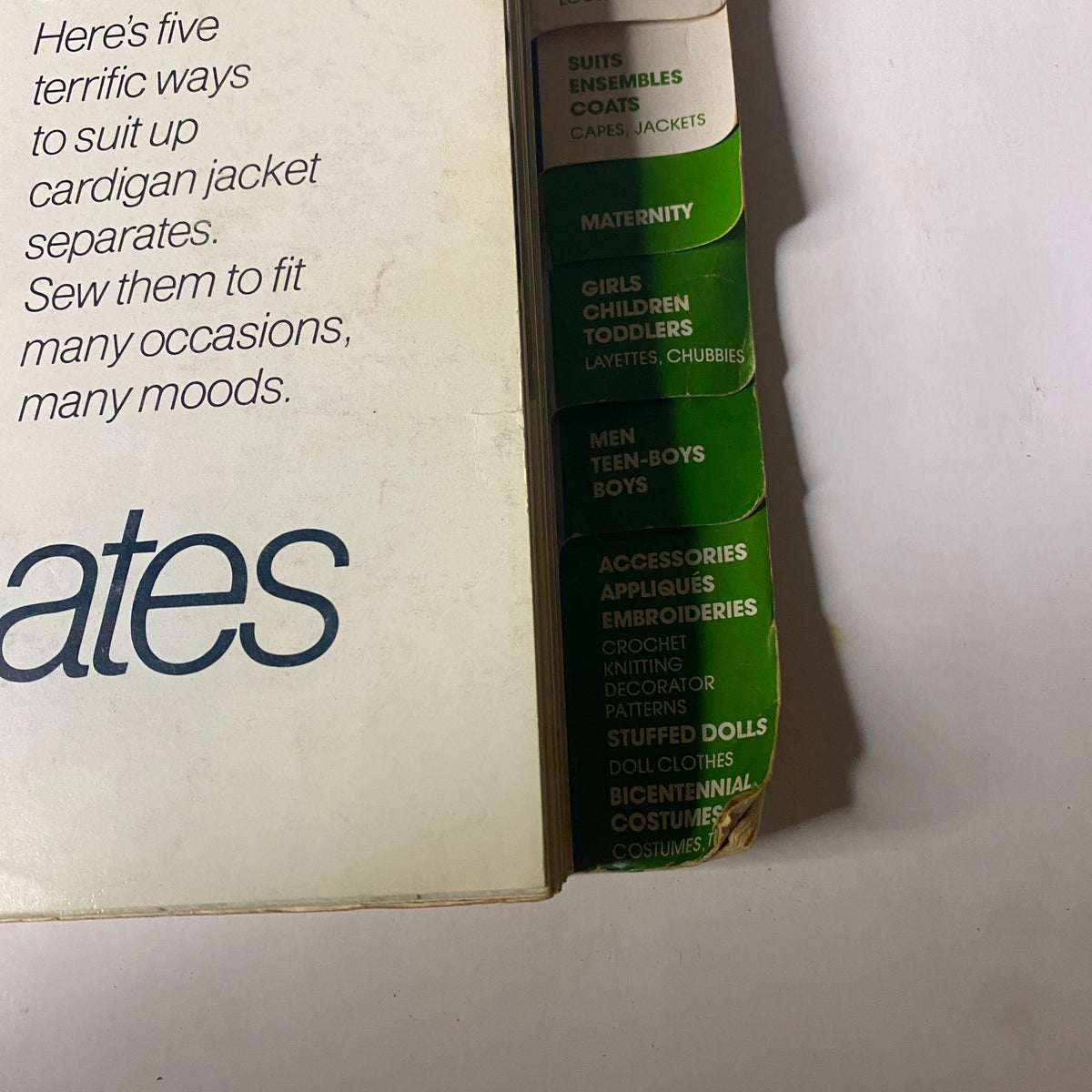 Cover of the 1975 April Simplicity Catalog featuring fashion patterns for suits, maternity, and children's clothing. The title reads 'Simplicity Catalog' with various categories listed.