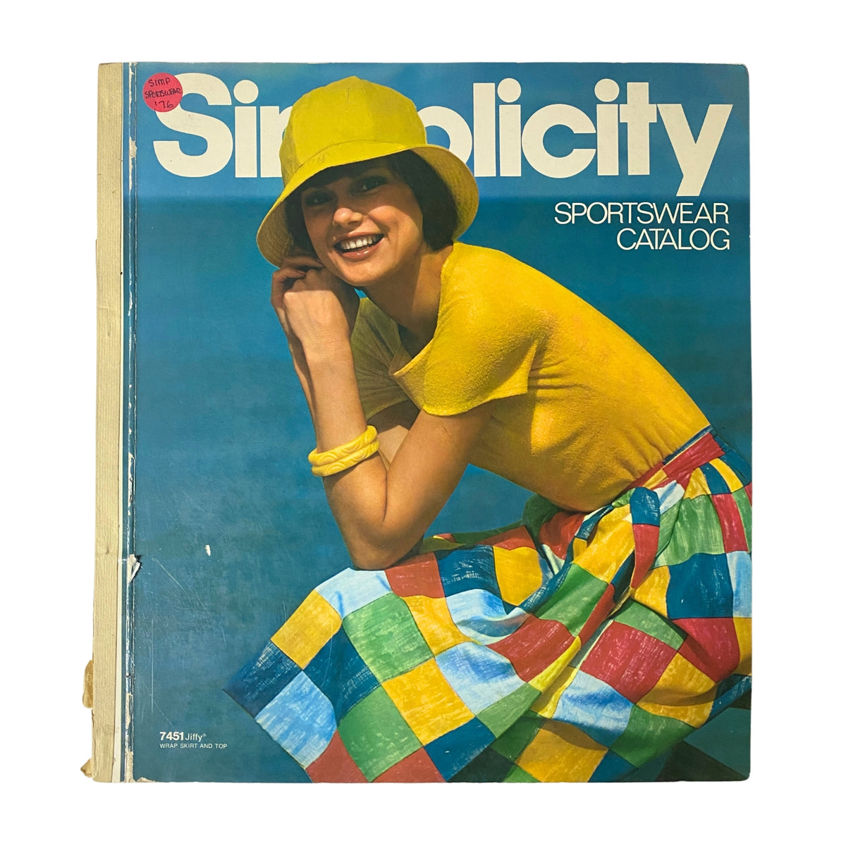 Cover of the 1976 Simplicity Sportswear Catalog featuring a smiling model in a vibrant yellow outfit and hat against a blue background, showcasing summer fashion styles.