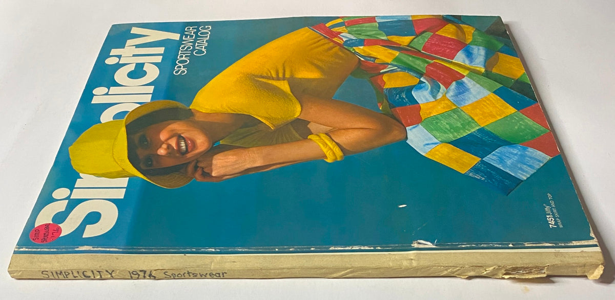 Front view of the 1976 Simplicity Sportswear Catalog displaying bright colors with a smiling model in a yellow hat and a colorful patterned skirt, promoting vintage sewing patterns.