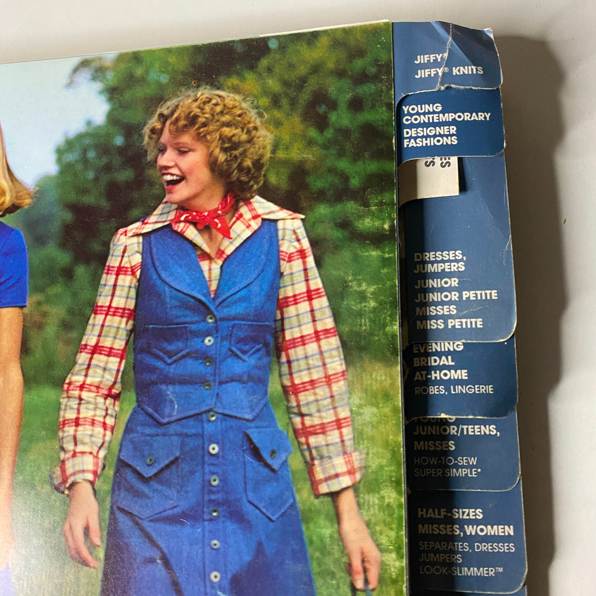 Close-up of the 1976 March Simplicity Catalog spine and contents, highlighting fashion categories such as JIFFY Knits and Young Contemporary Designer Fashions.