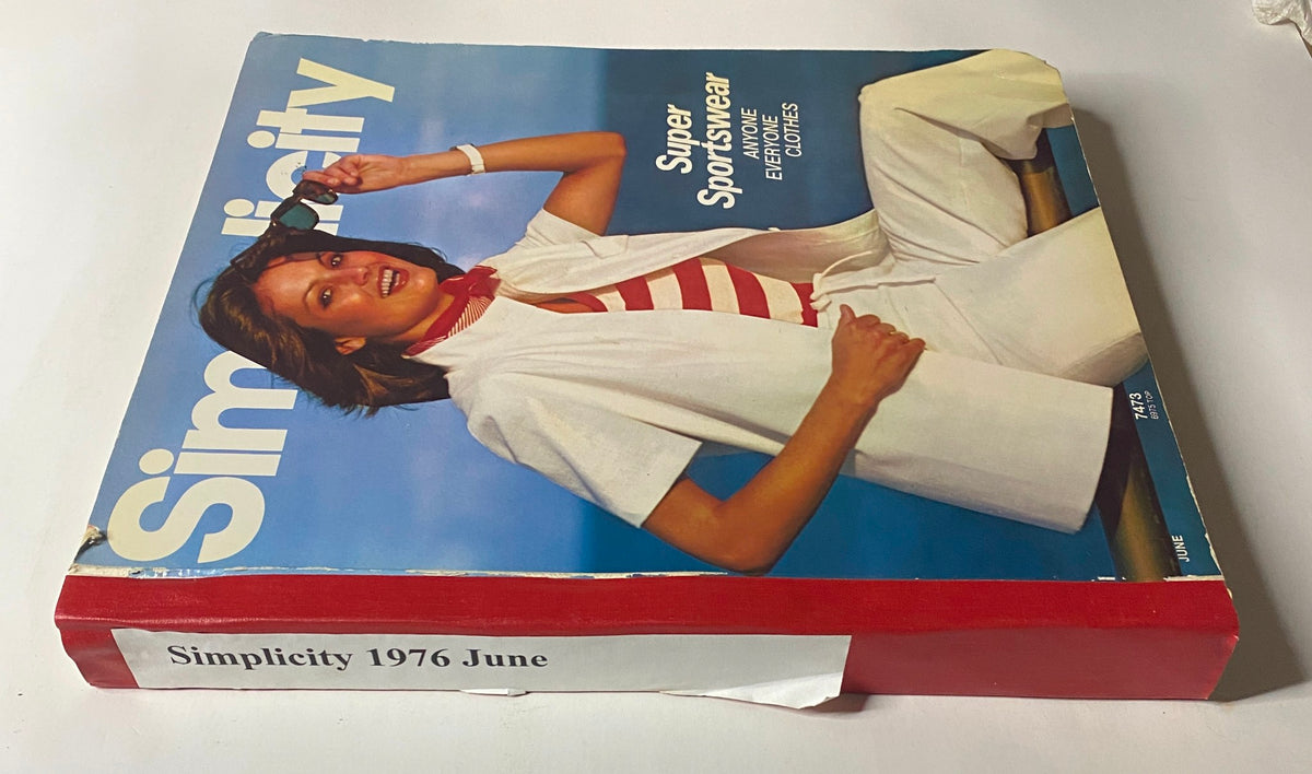 Side view of the 1976 June Simplicity Catalog featuring 'Super Sportswear,' emphasizing its vibrant cover with a model in white attire and red accents.