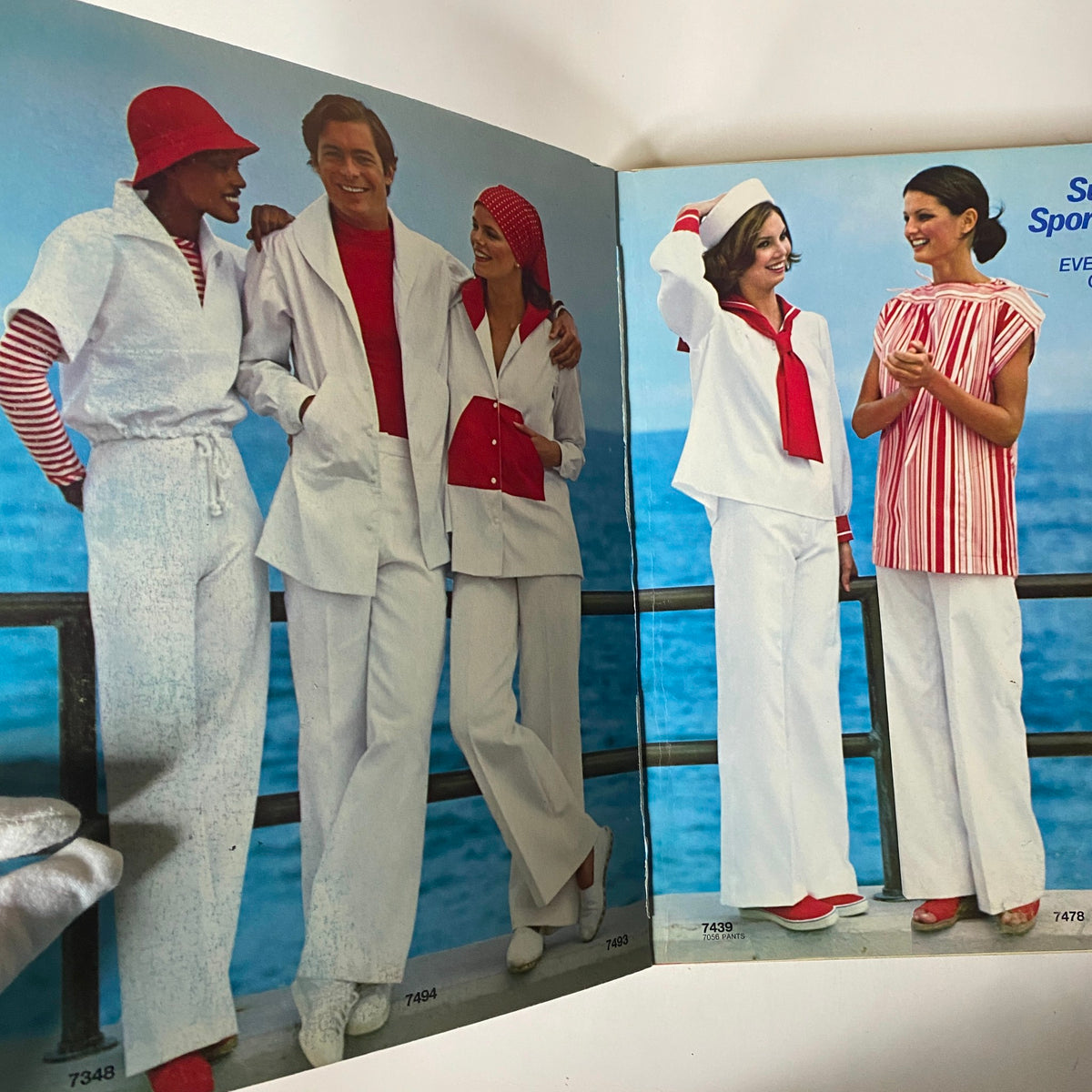 Interior spread of the 1976 June Simplicity Catalog, displaying a group of models in fashionable outfits including those from the 'Super Sportswear' collection.