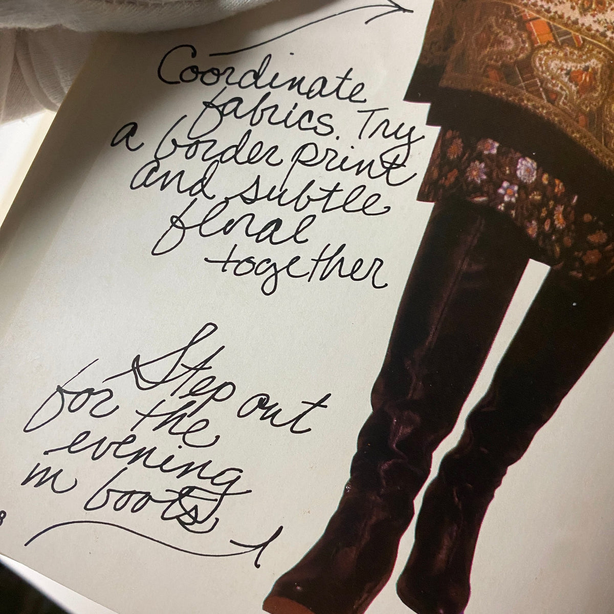 Close-up image from the 1977 Simplicity Fall Catalog displaying a fashion suggestion for coordinating fabrics, featuring handwritten advice on styling boots and floral prints.