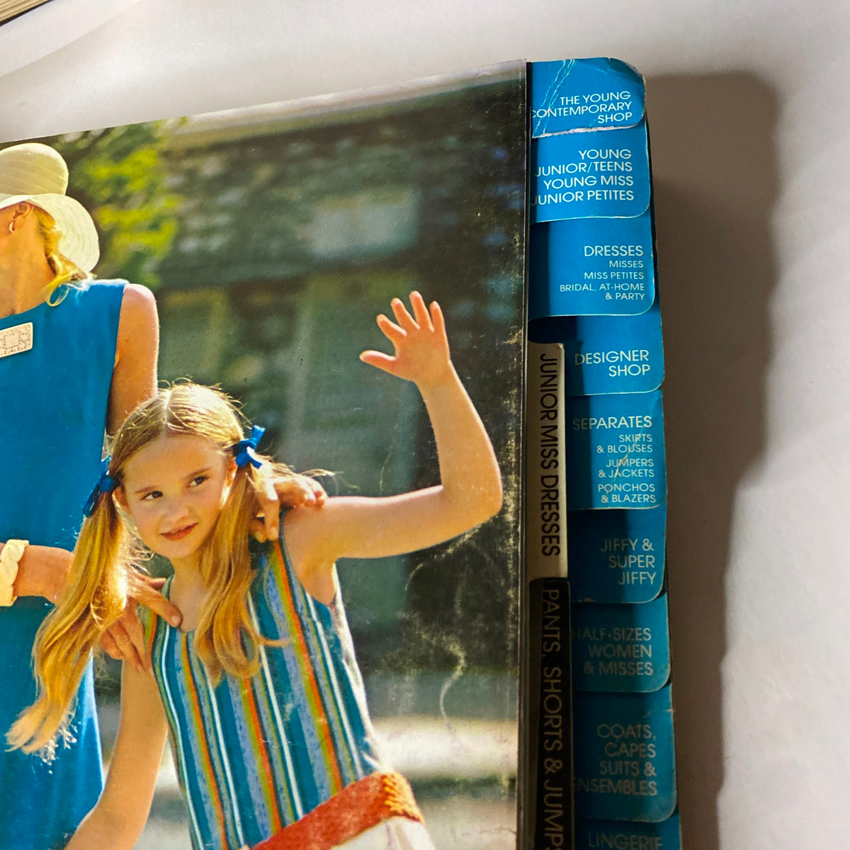 1970s May Simplicity Sewing Pattern Catalog Store Counter Book spine featuring sections like The Young Contemporary Shop and Dresses, showcasing categories for various styles.