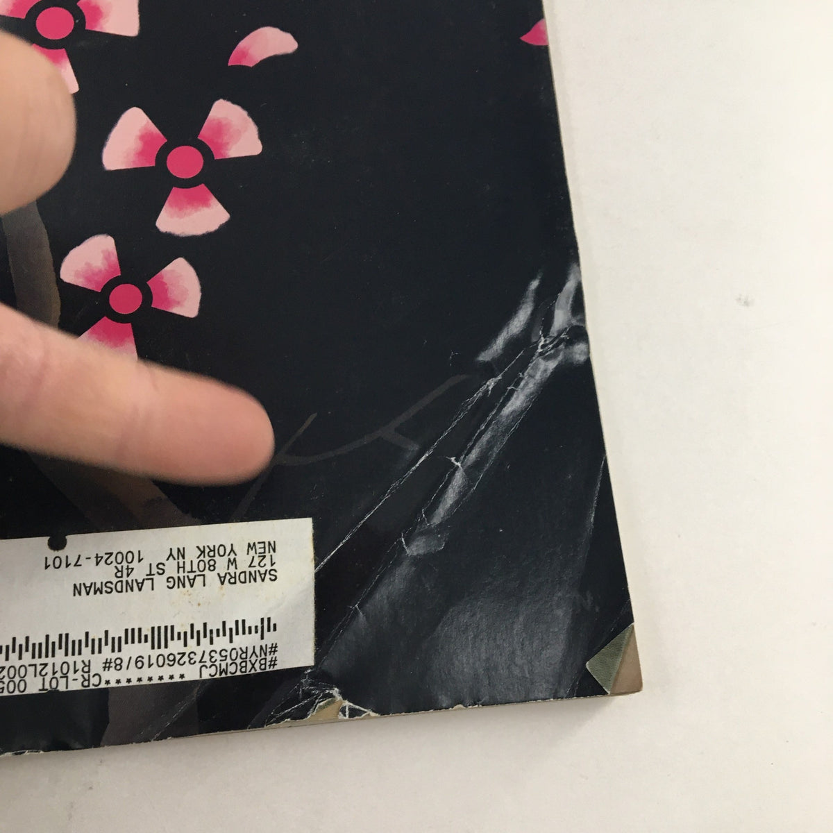 Close-up of the bottom corner of The New Yorker March 28 2011 magazine cover, highlighting the vintage address label and tattered edges.