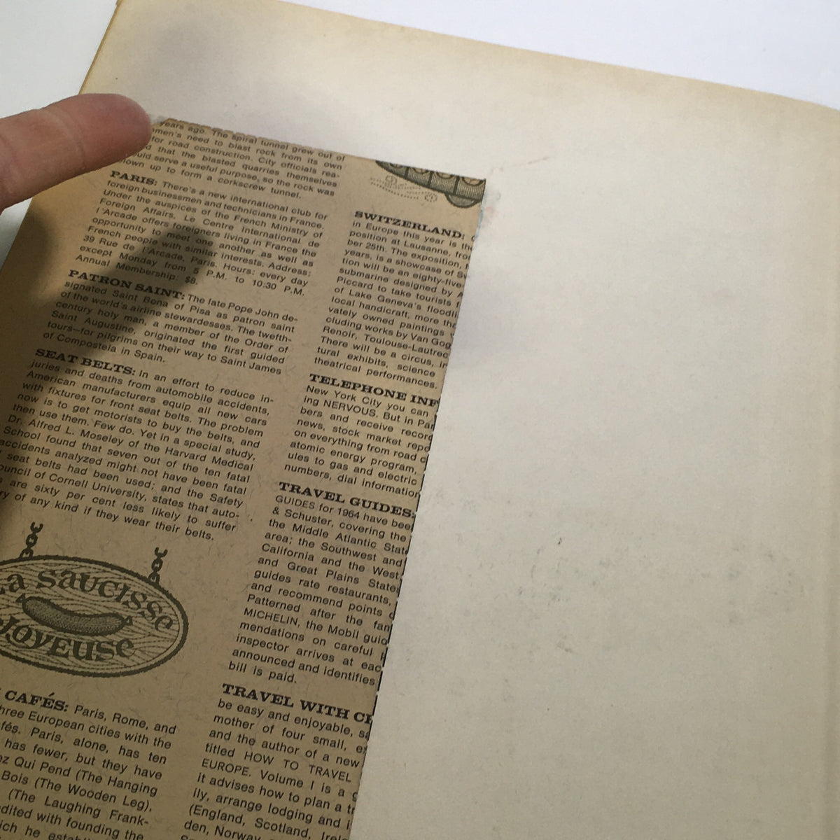Back side of an inside page of the VTG Venture Magazine Book: June 1964, featuring a cutout section and travel guides, emphasizing the historical context of travel during the 1960s.
